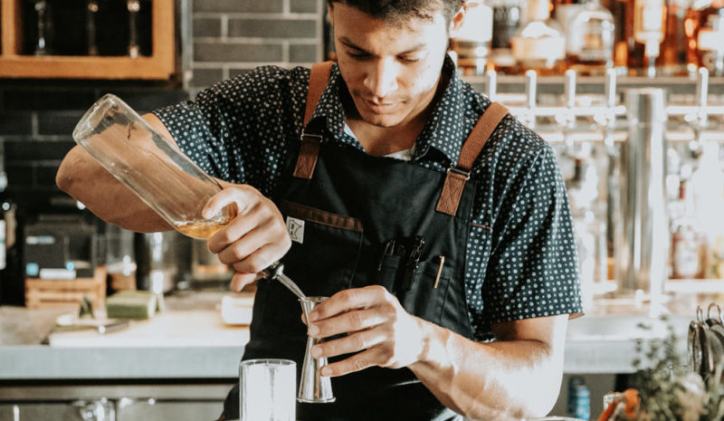 Bartender pouring a drink at our Minneapolis boutique hotel