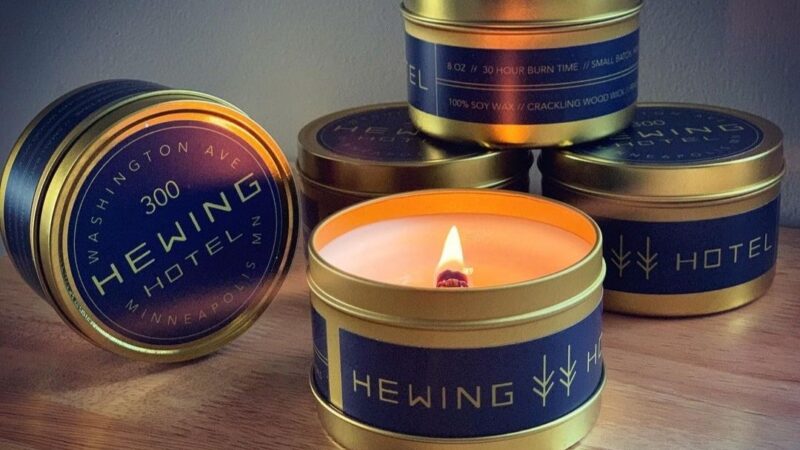 Round metal tins with Hewing Hotel branded candles