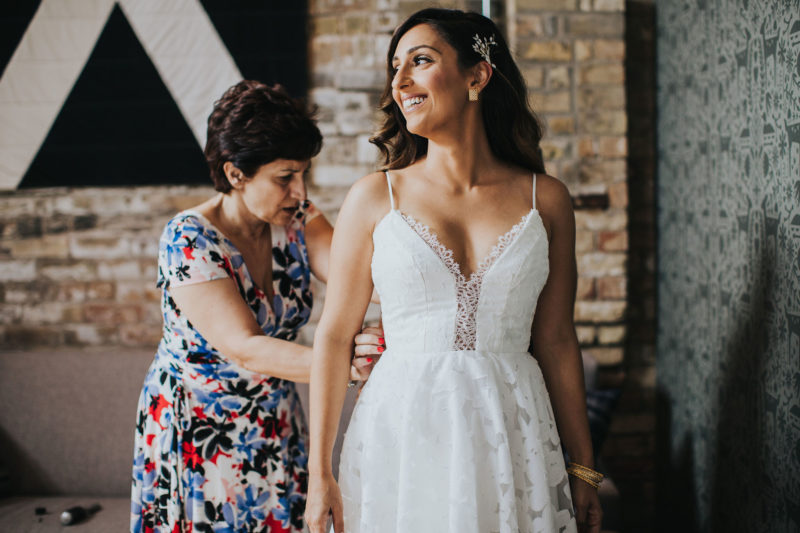 Mother helping a bride with her wedding dress at our Minneapolis hotel