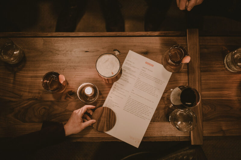 Cocktails on a wooden bar at our boutique hotel in Minneapolis, MN