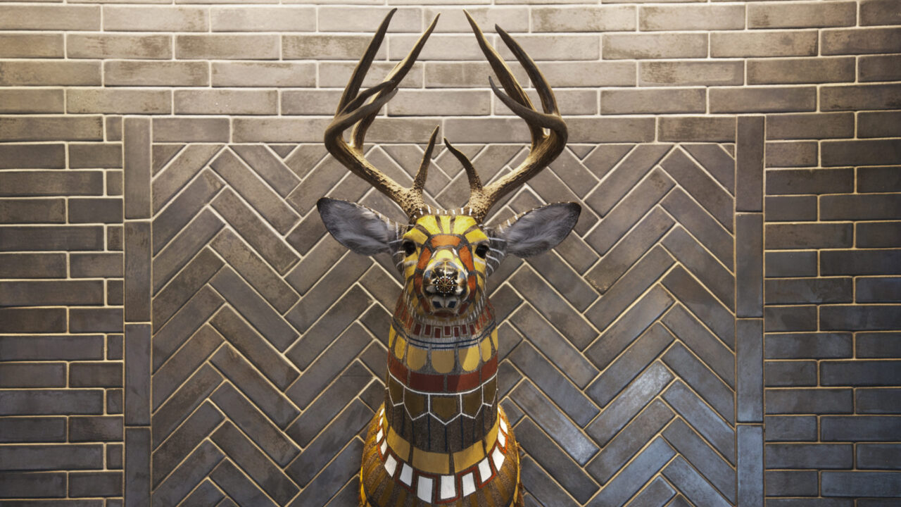 Colorful geometric painted deer head on the wall of our Minneapolis boutique hotel