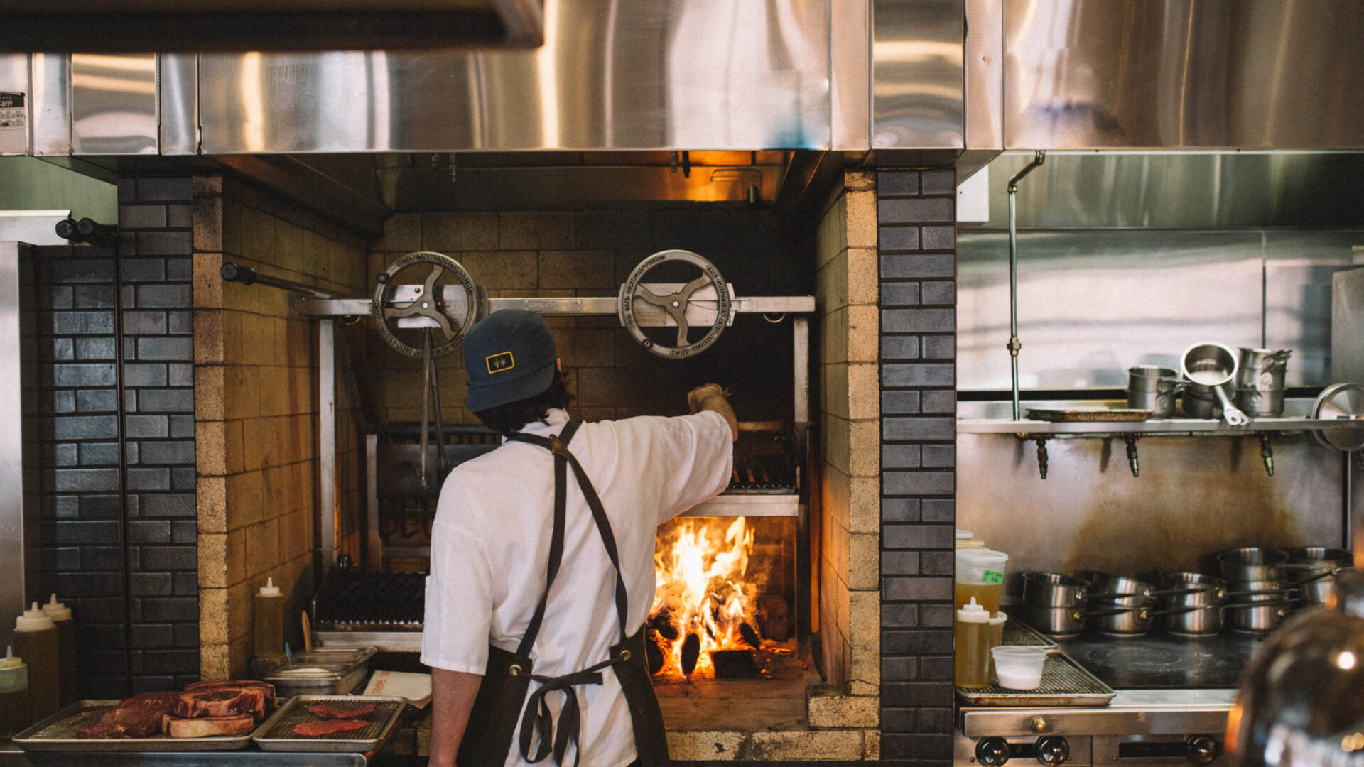 Cook working over an open fire at our downtown Minneapolis restaurant