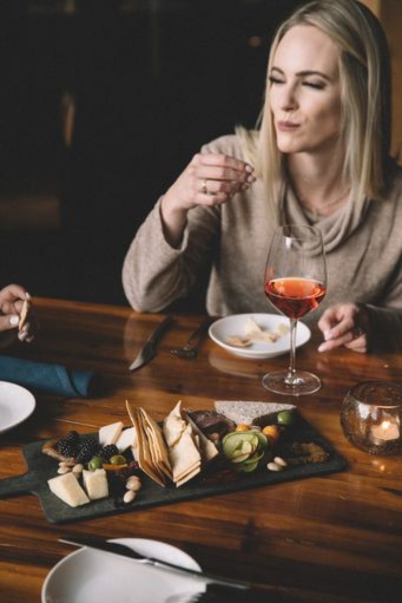 Woman with charcuterie and wine at our Minneapolis boutique hotel