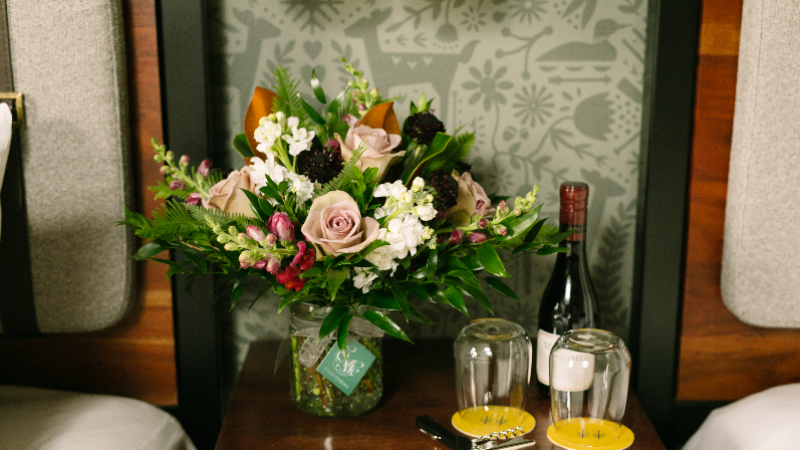 Boutique, two wine glasses and a bottle of wine in a Hewing Hotel room