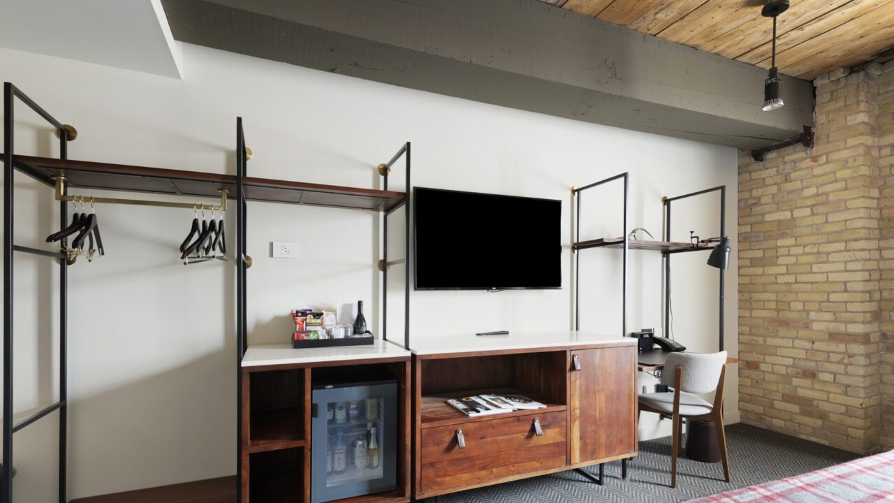 TV, dresser, and wardrobe area in a room at our downtown MPLS hotel